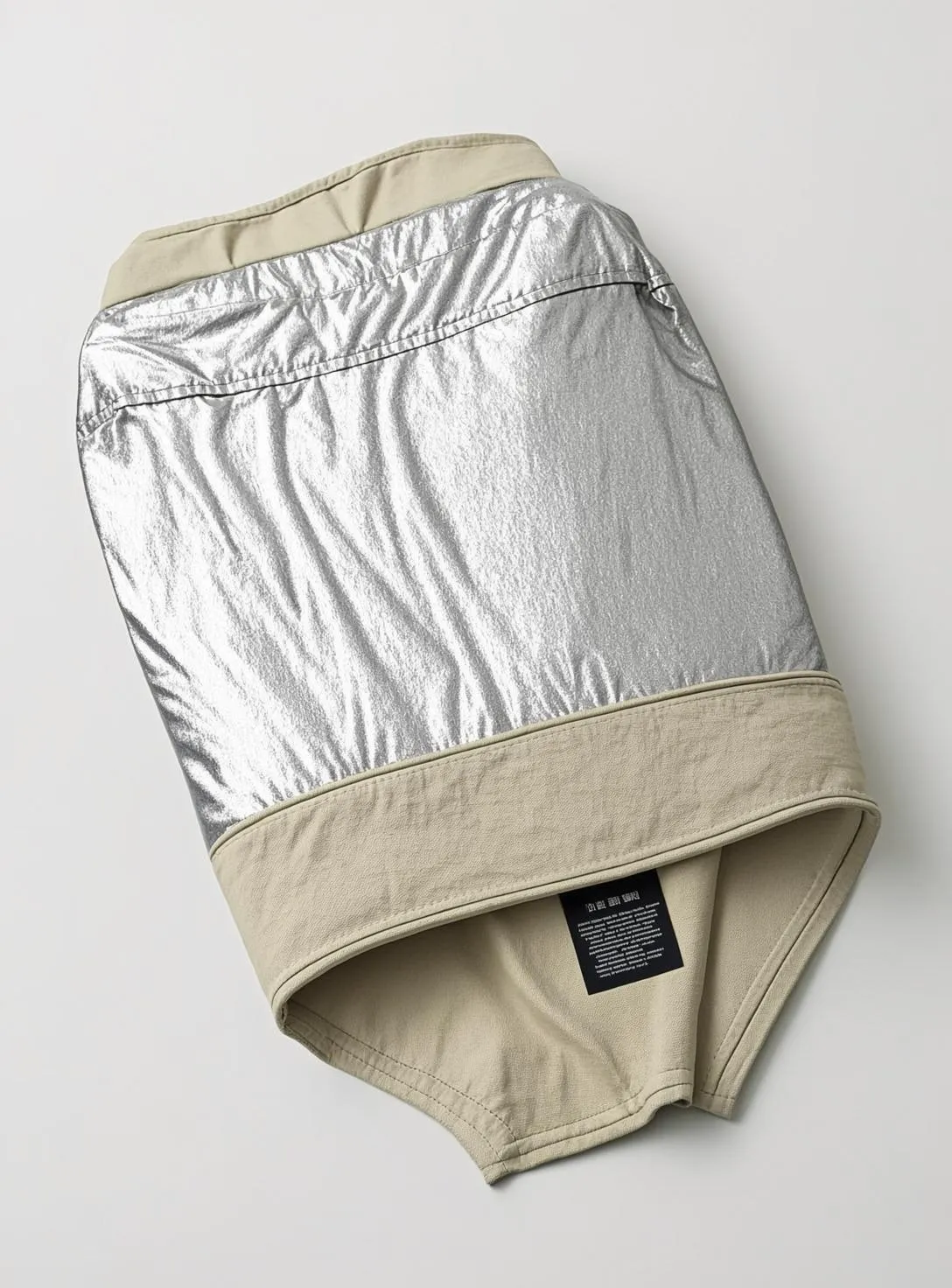 Product photograph of a small aluminised fire-resistant garment for a cat, shown flat on a white background.